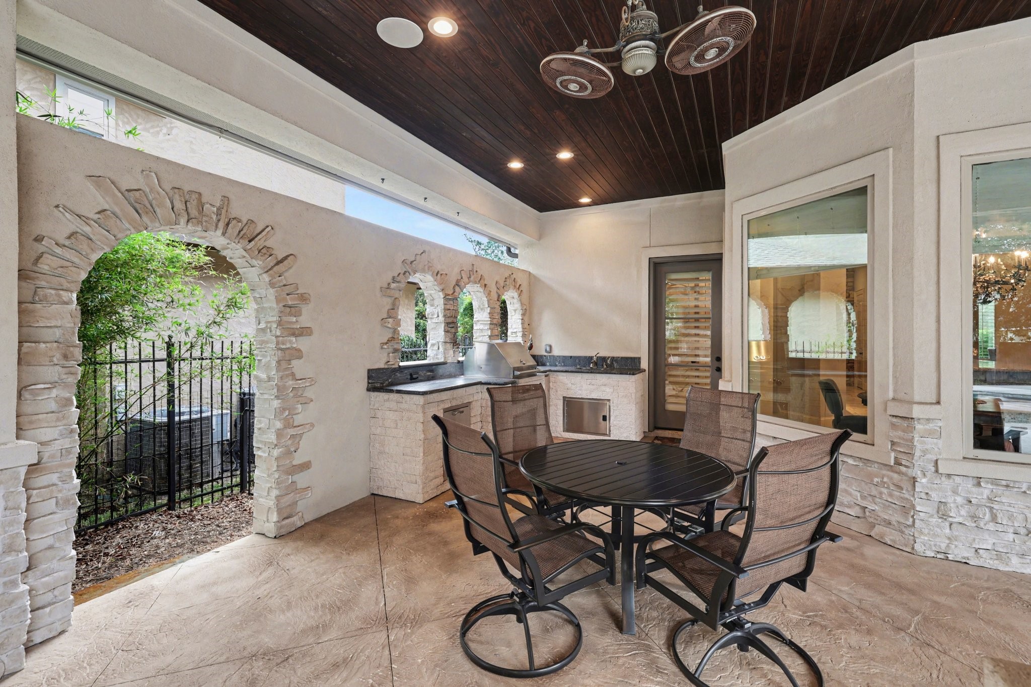 3 Player Ridge Court The Woodlands, TX 77382 - Photo 38 of 50 View of the outdoor kitchen featuring a grill, sink, outdoor refrigerator, and space for a dining table, perfect for outdoor dining.