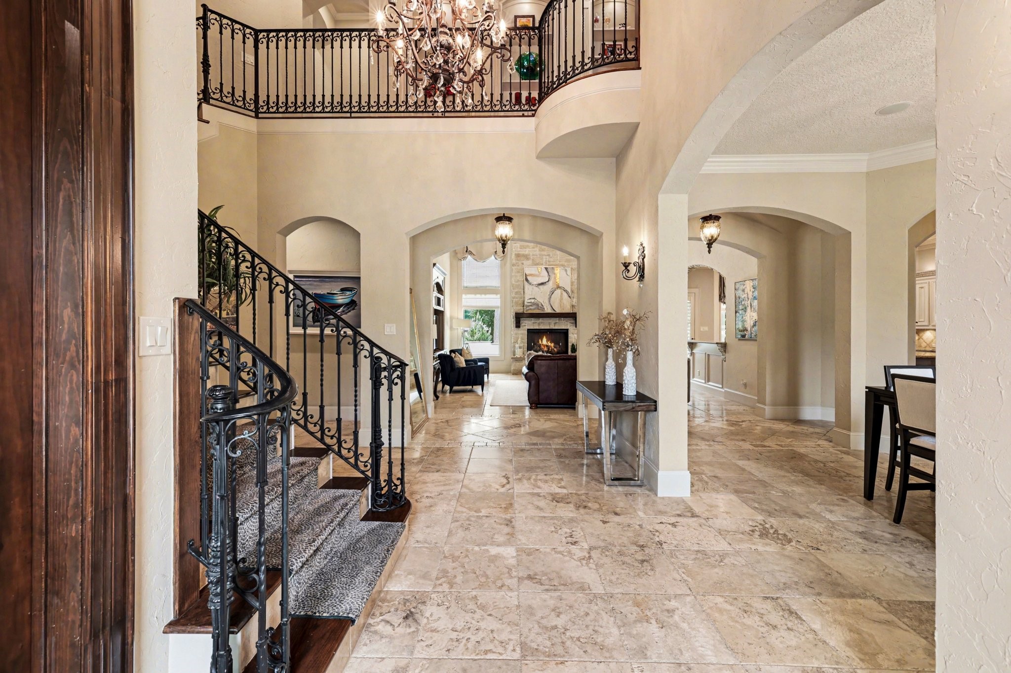 3 Player Ridge Court The Woodlands, TX 77382 - Photo 4 of 50 Striking entry with soaring ceilings, curved staircase, and elegant architectural details.