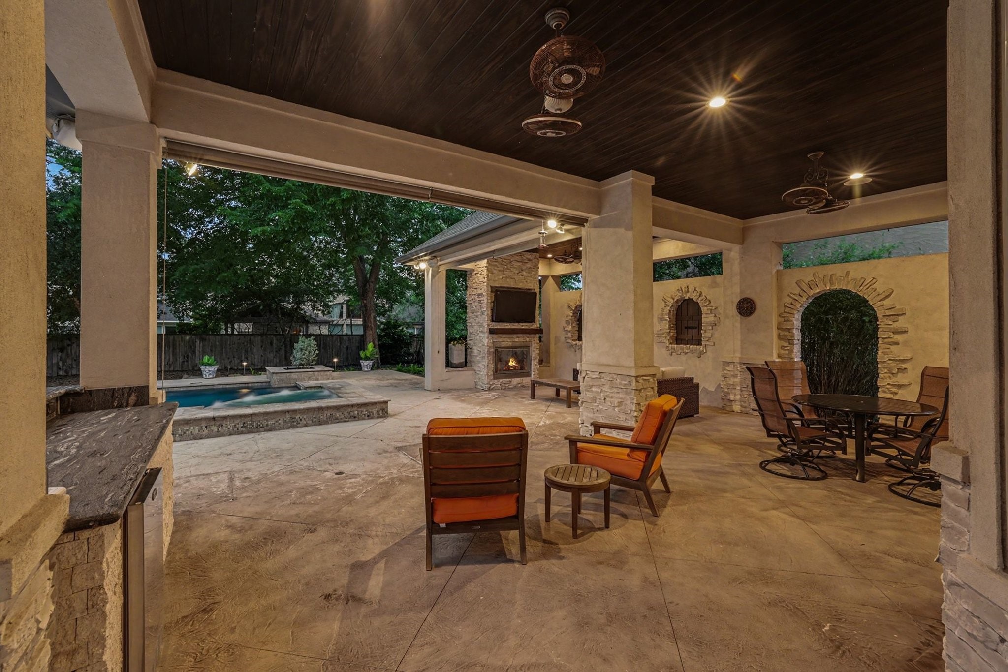 3 Player Ridge Court The Woodlands, TX 77382 - Photo 42 of 50 Twilight view of this exceptional outdoor living space with a covered patio, fireplace, and upscale finishes.