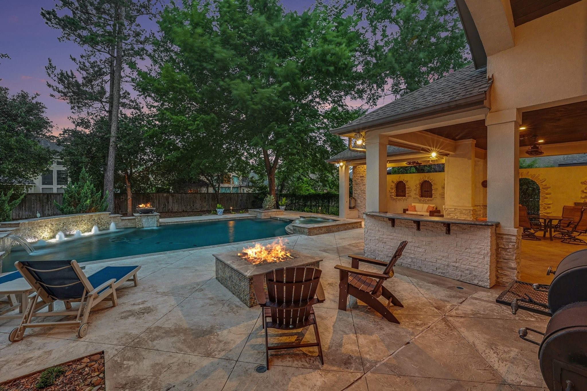 3 Player Ridge Court The Woodlands, TX 77382 - Photo 46 of 50 Imagine evenings spent relaxing by this remarkable pool and outdoor kitchen.