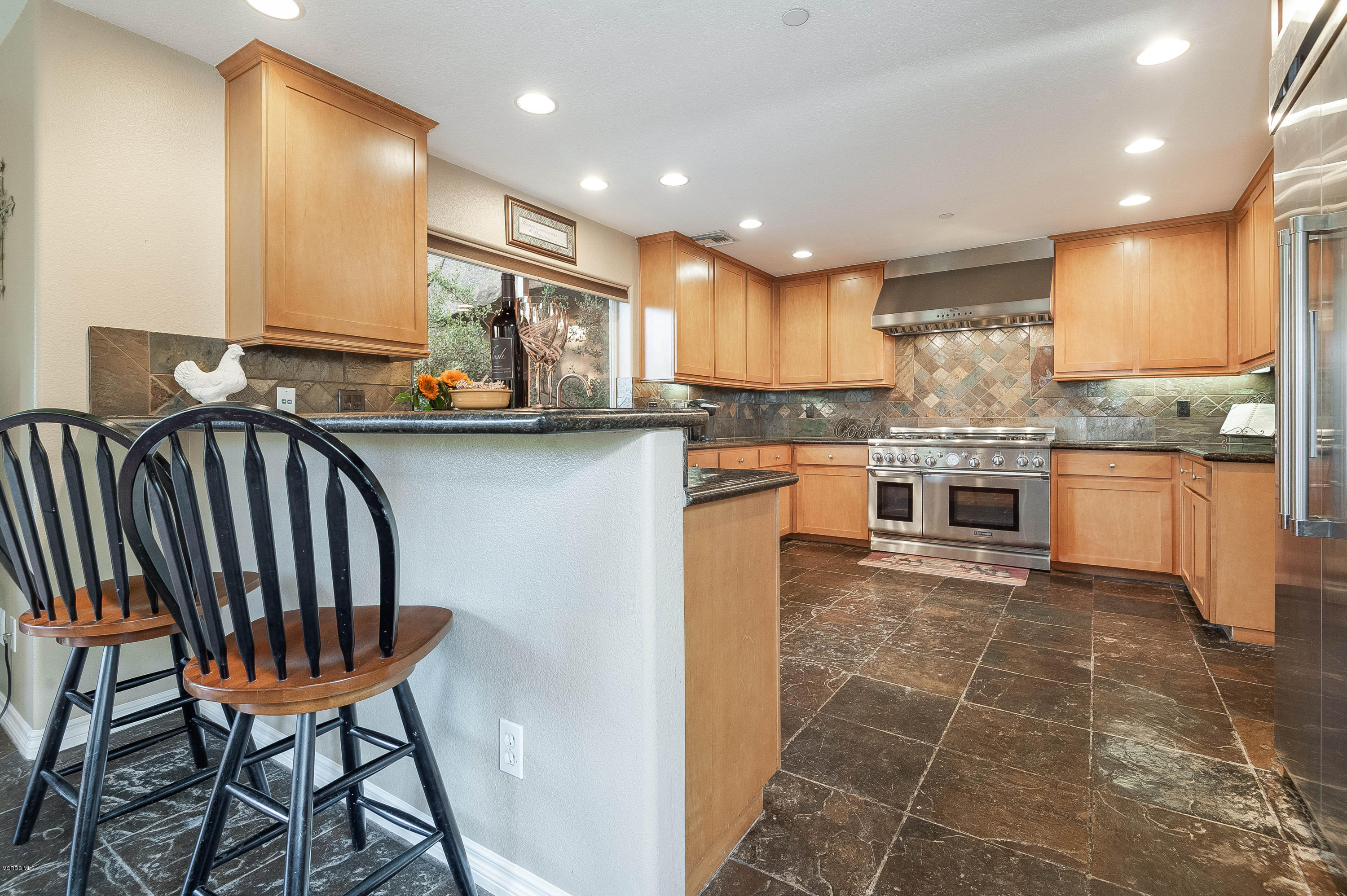 1079 Katherine Road Simi Valley, CA 93063 - Photo 11 of 53 a kitchen with stainless steel appliances granite countertop a table chairs sink and cabinets