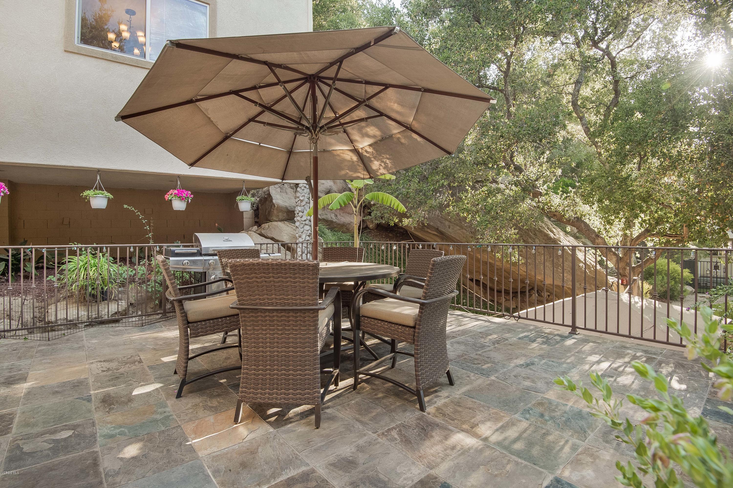 1079 Katherine Road Simi Valley, CA 93063 - Photo 16 of 53 a view of a patio with a table and chairs under an umbrella