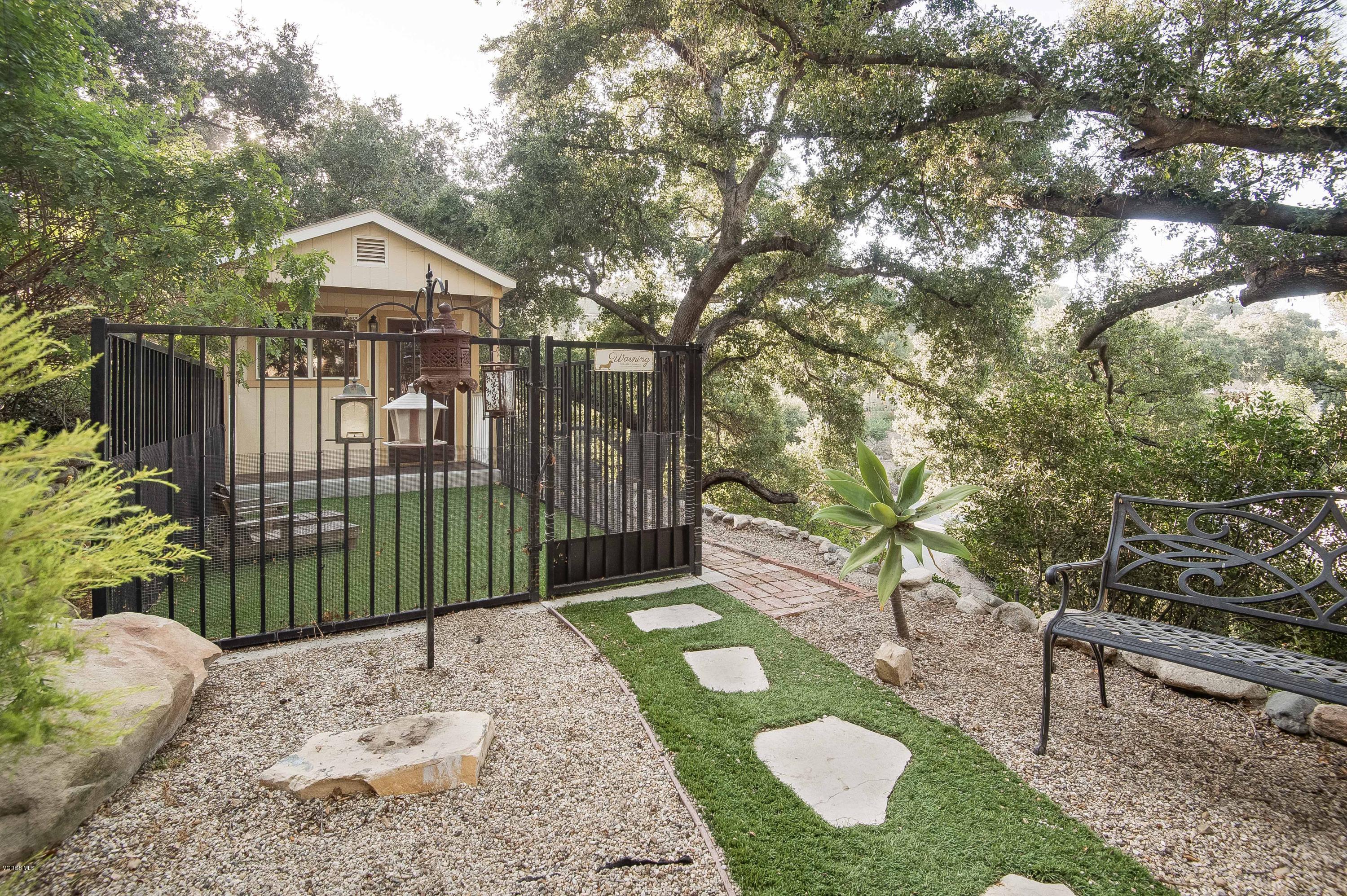1079 Katherine Road Simi Valley, CA 93063 - Photo 17 of 53 a view of a brick house with a small yard and plants