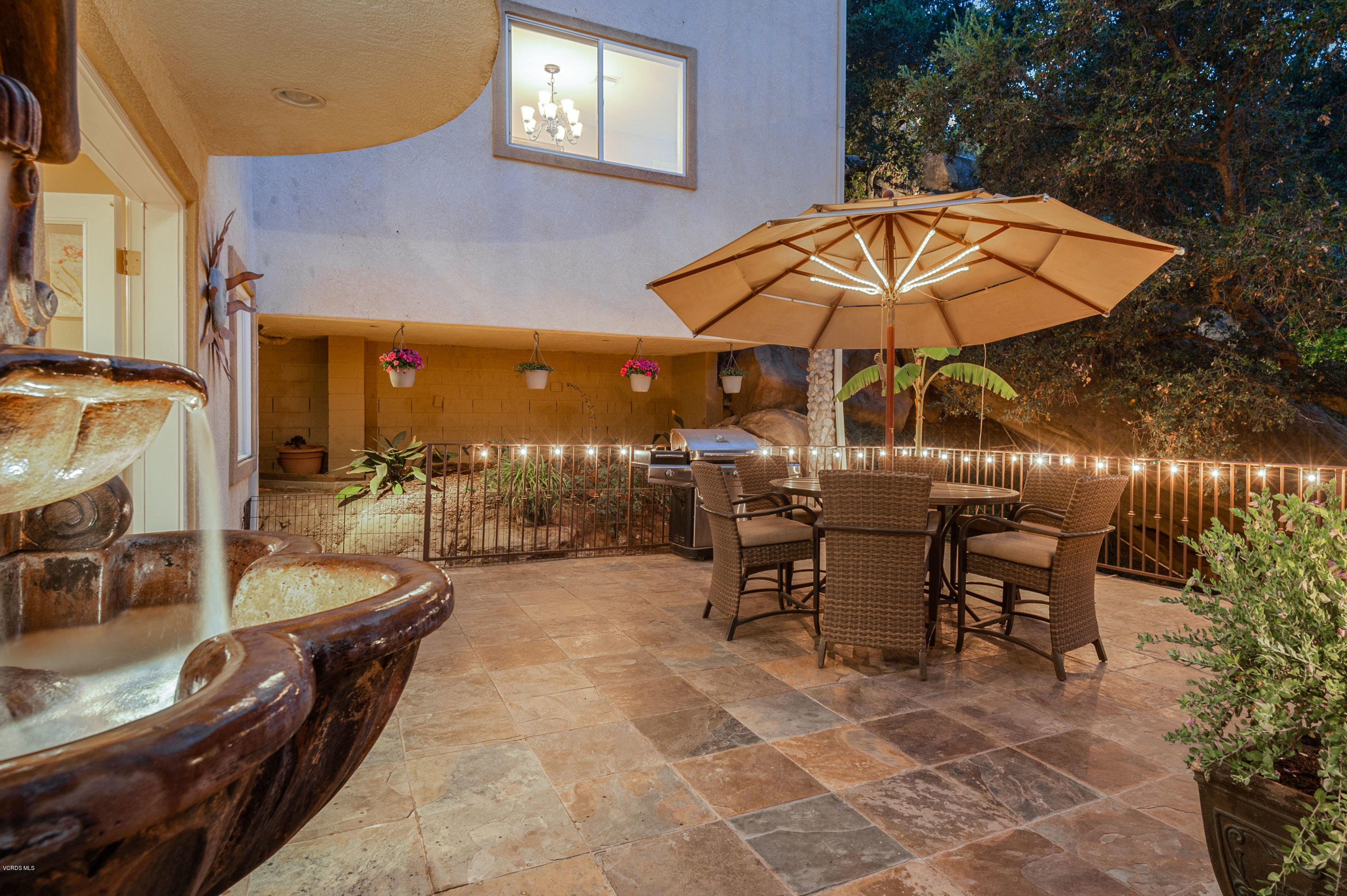 1079 Katherine Road Simi Valley, CA 93063 - Photo 42 of 53 a view of a patio with dining table and chairs under an umbrella