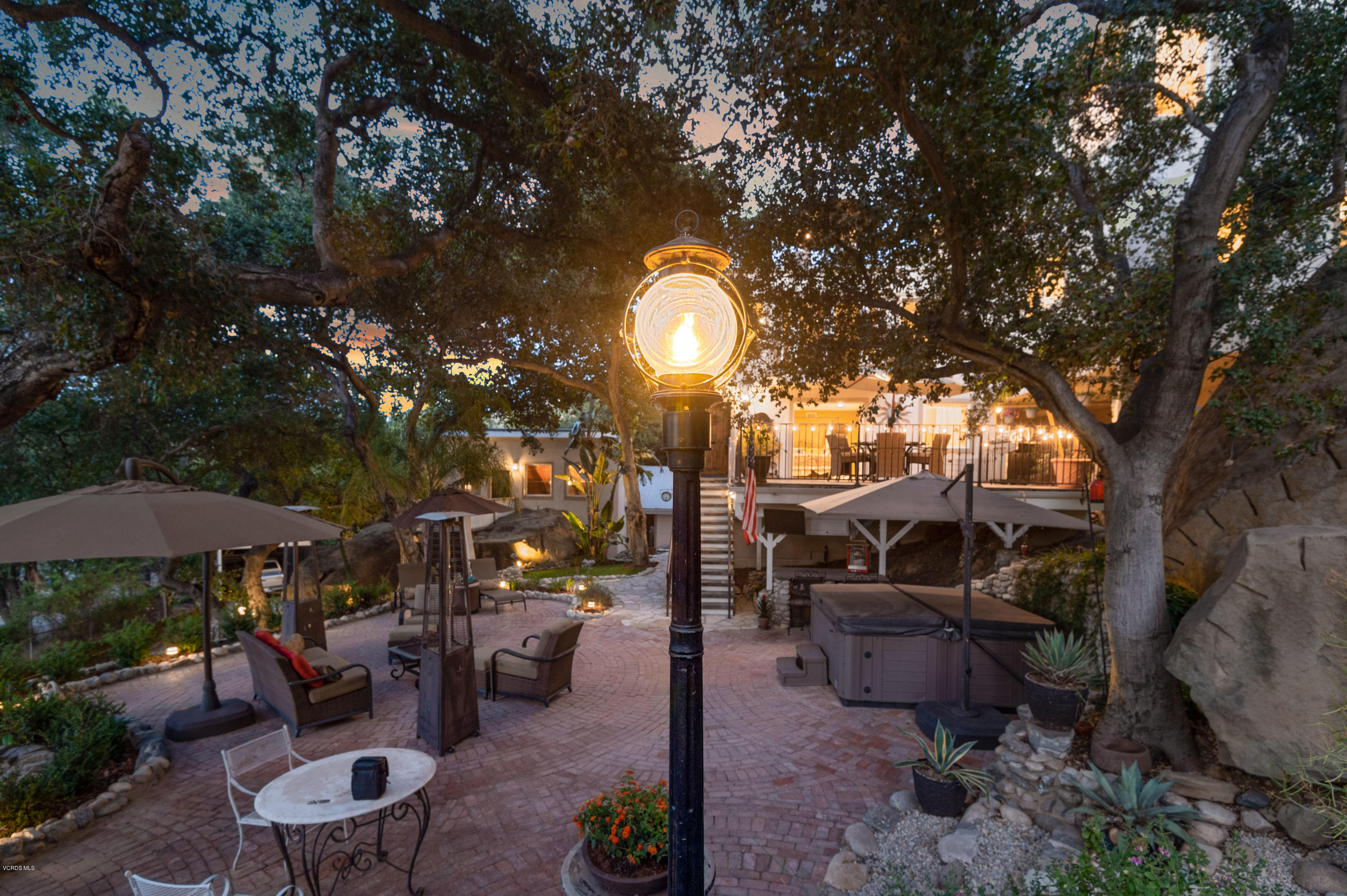 1079 Katherine Road Simi Valley, CA 93063 - Photo 44 of 53 a view of a patio with couches table and chairs under an umbrella with large trees