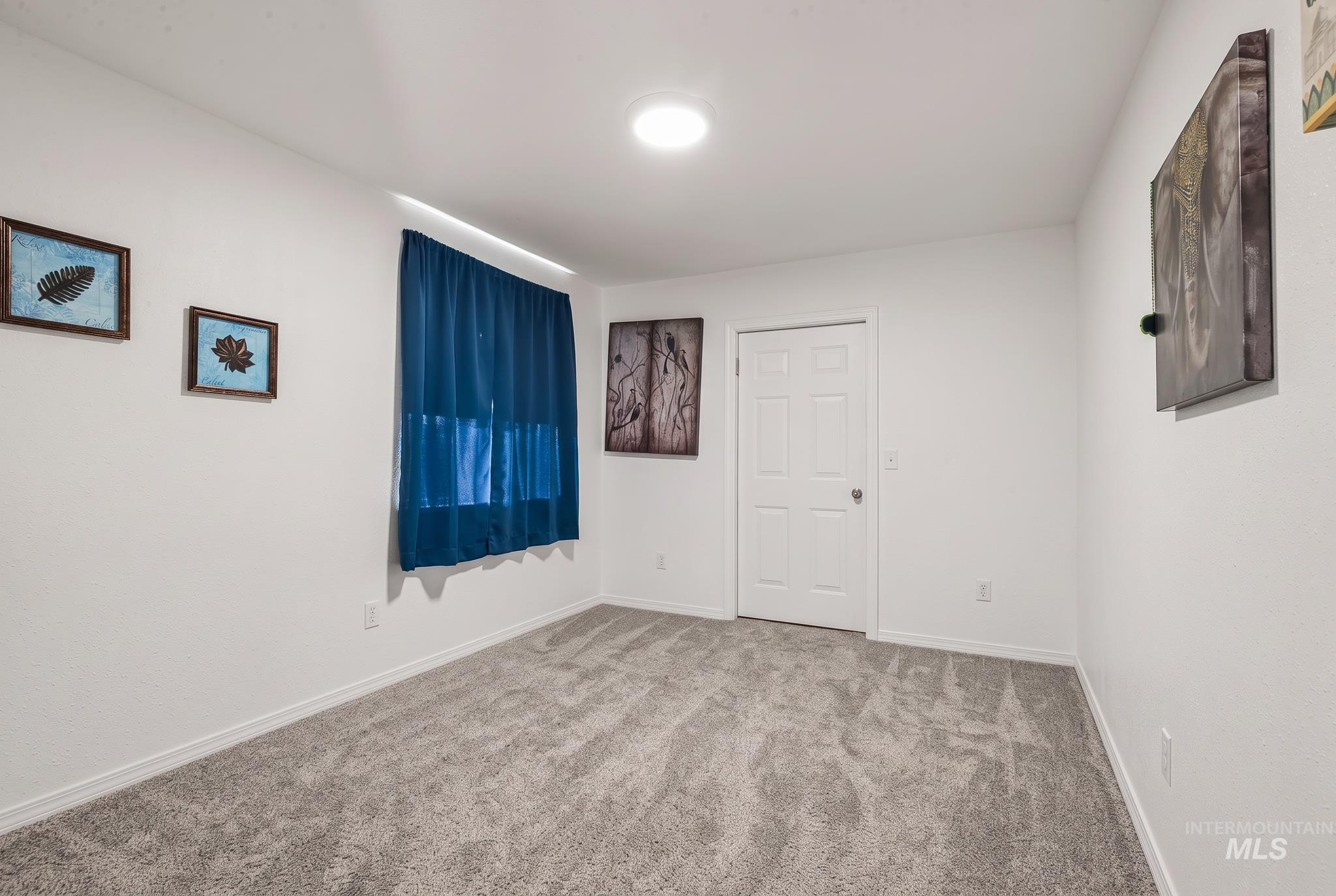 905 Fountain Street Colton, WA 99113 - Photo 30 of 34 White painted walls, gray patterned carpeting, recessed ceiling lighting, and a white interior door