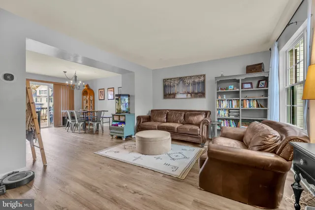 a living room with furniture and a book shelf