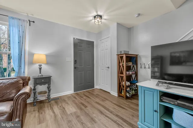 a view of a livingroom with furniture and a flat screen tv
