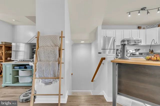 a kitchen with kitchen island a sink appliances and cabinets
