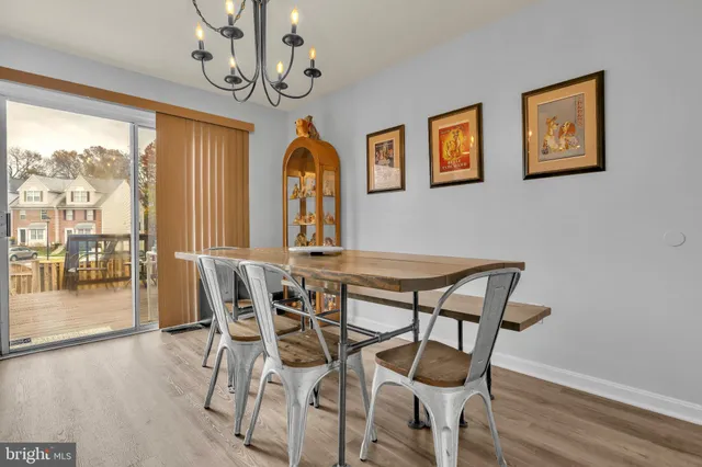 a view of a dining room with furniture wooden floor and a chandelier