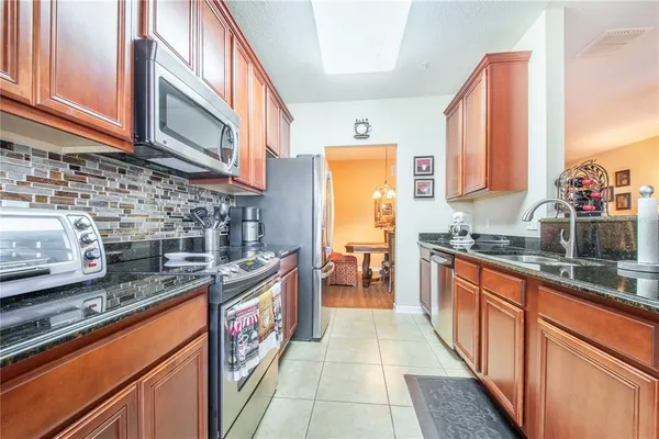 a kitchen with stainless steel appliances granite countertop a stove and a refrigerator
