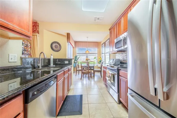 a view of a dining room with furniture a chandelier and wooden floor