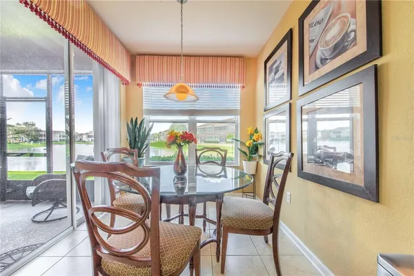 a view of a dining room and livingroom with furniture wooden floor and a chandelier