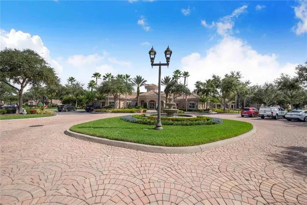 a living room with fireplace furniture and a large window