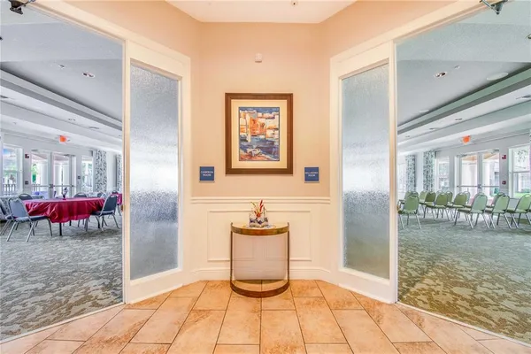 a room with furniture pool table and windows