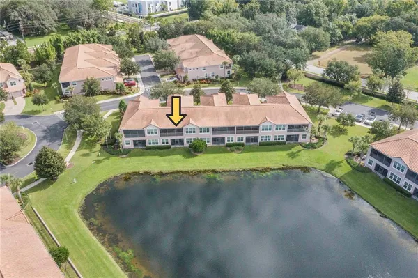 an aerial view of a house with a garden and houses