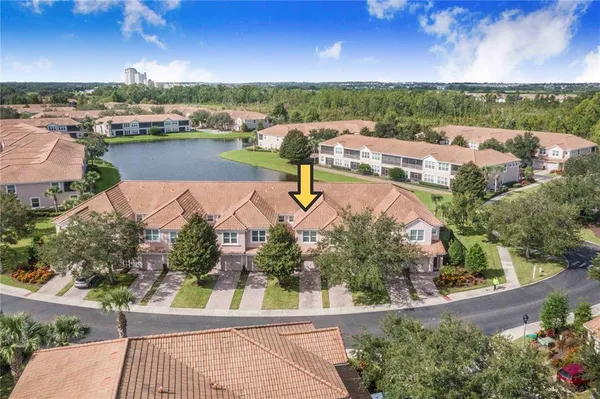 an aerial view of a house with a garden and lake view