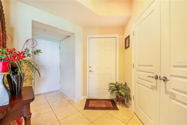 a view of living room with furniture and a potted plant