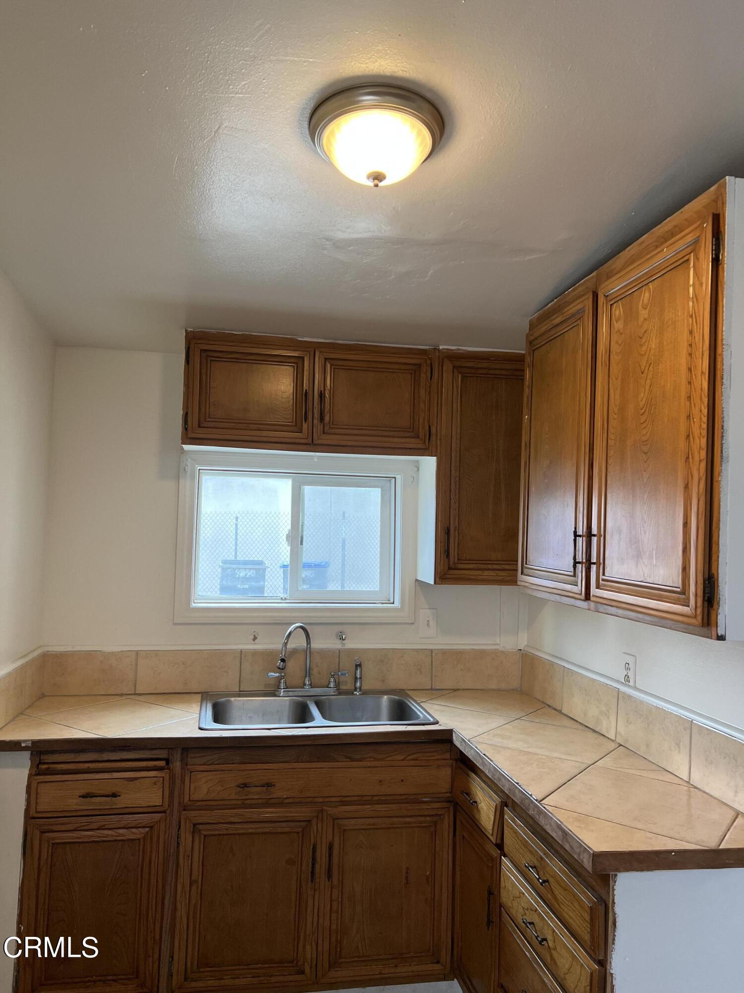 4840 Saviers Road Oxnard, CA 93033 - Photo 14 of 24 a kitchen with a sink cabinets and window