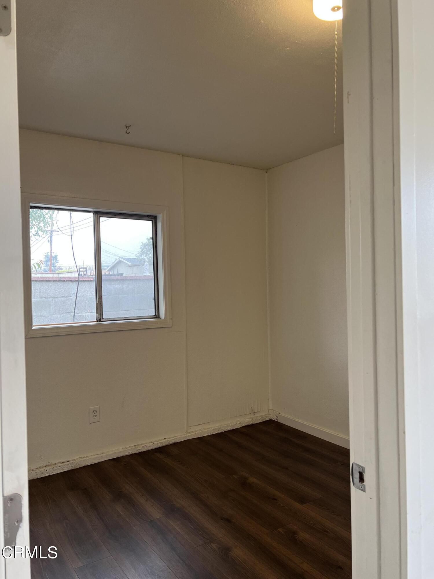 4840 Saviers Road Oxnard, CA 93033 - Photo 16 of 24 a view of an empty room with wooden floor and a window