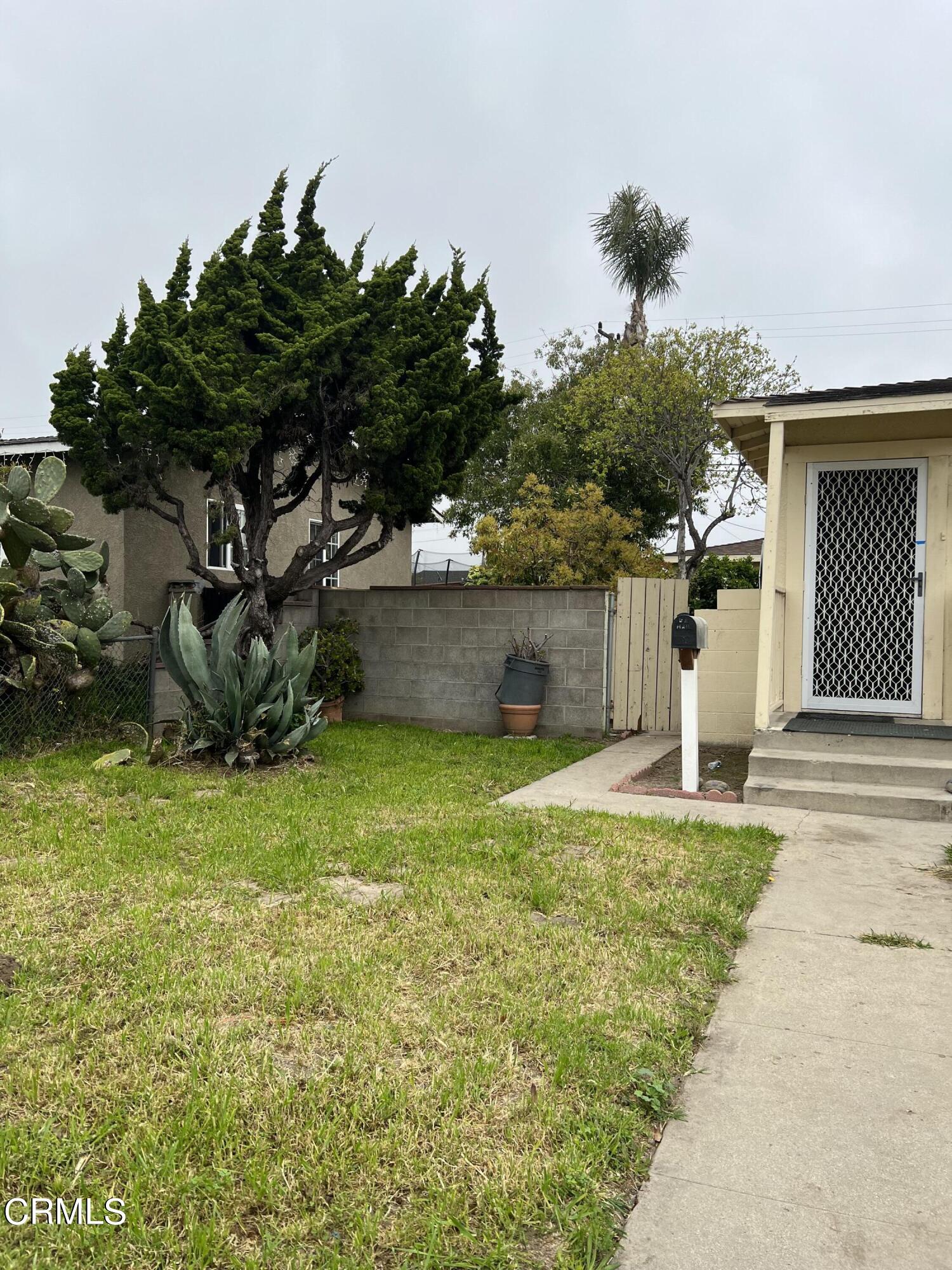 4840 Saviers Road Oxnard, CA 93033 - Photo 2 of 24 a front view of a house with a garden and yard