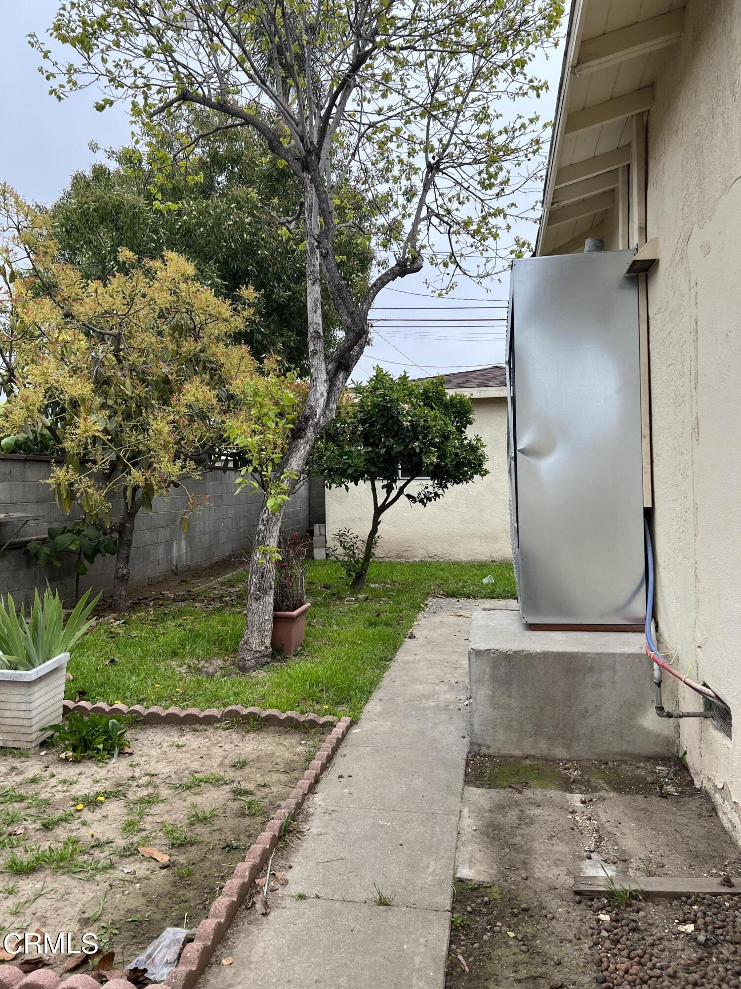 4840 Saviers Road Oxnard, CA 93033 - Photo 3 of 24 a pathway of a house with a yard