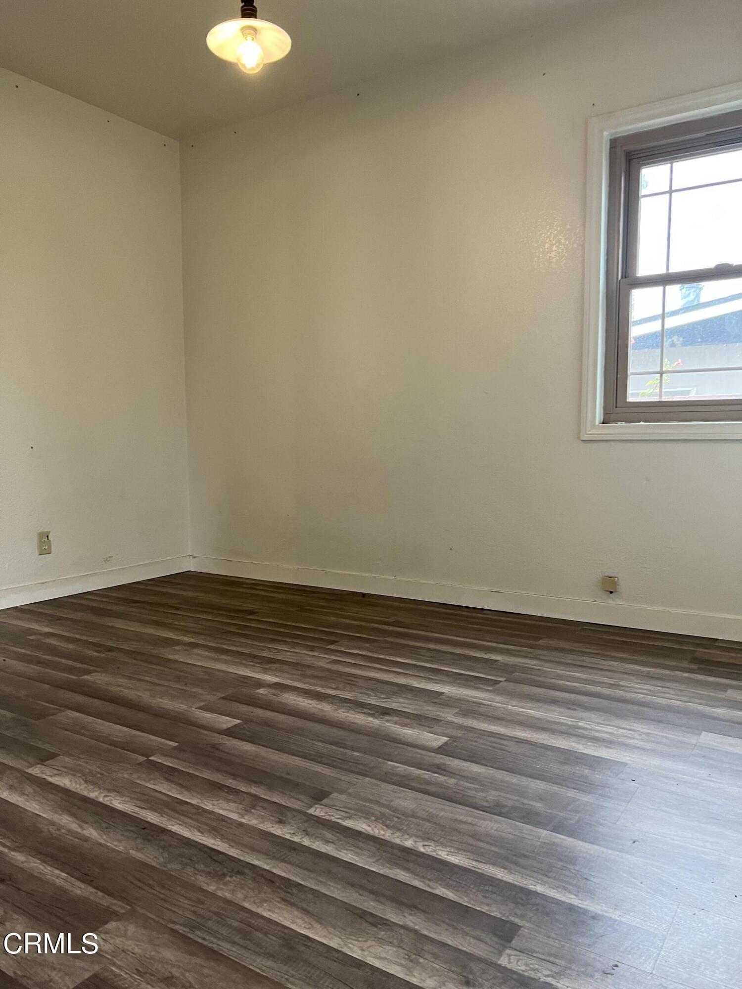 4840 Saviers Road Oxnard, CA 93033 - Photo 4 of 24 a view of a room with wooden floor and white walls