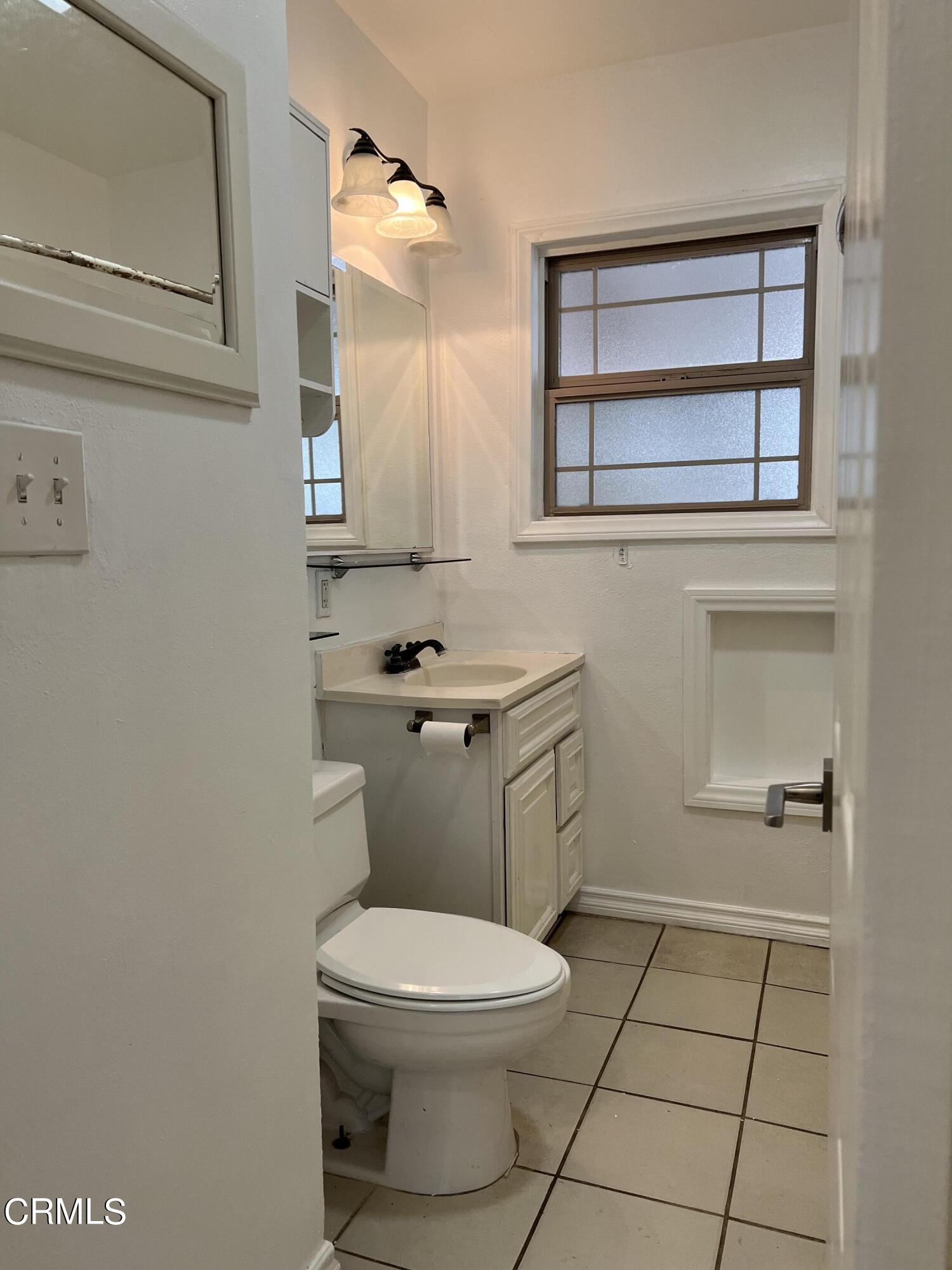 4840 Saviers Road Oxnard, CA 93033 - Photo 8 of 24 a bathroom with a toilet a sink and mirror