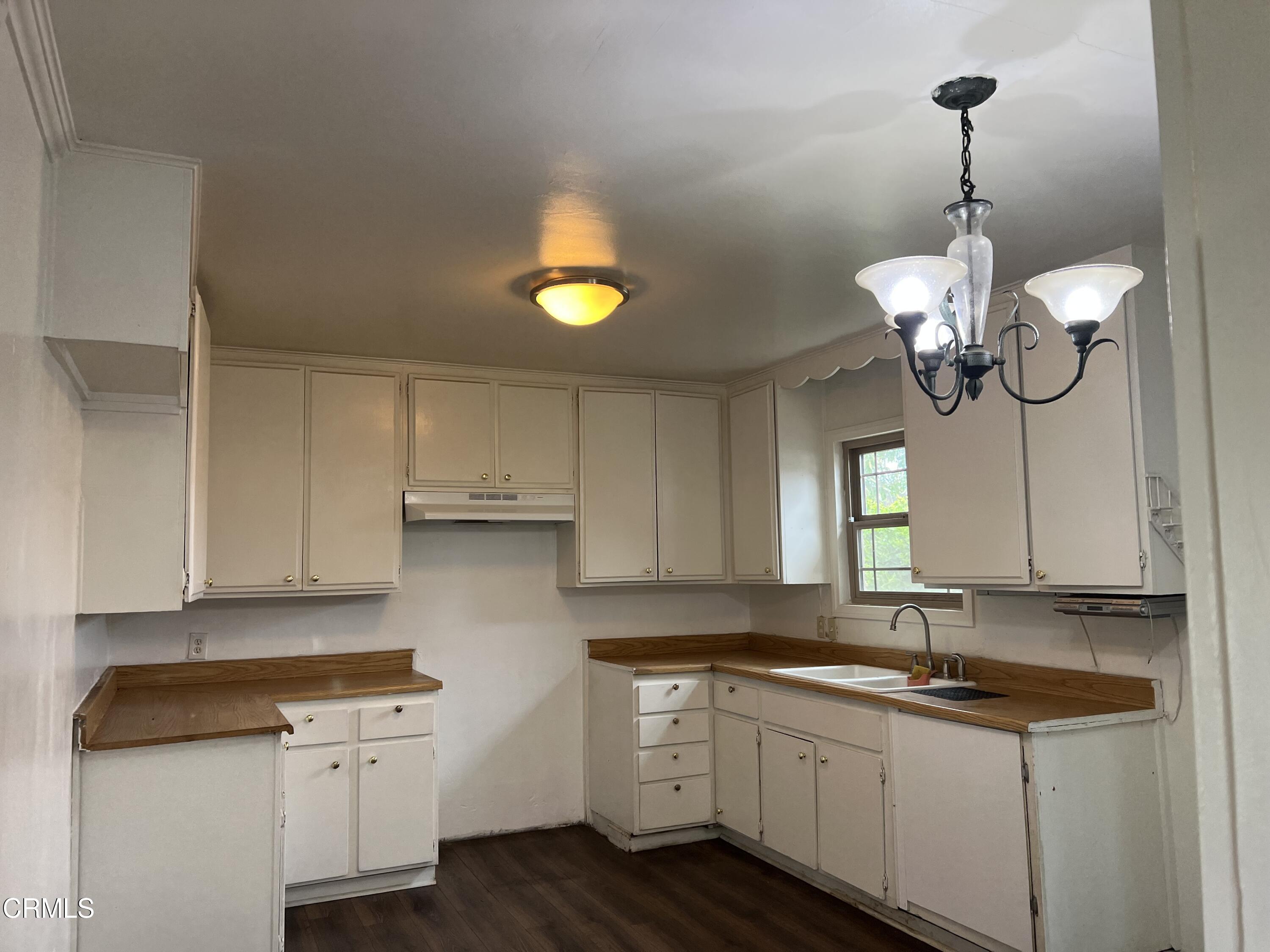 4840 Saviers Road Oxnard, CA 93033 - Photo 9 of 24 a kitchen with a sink cabinets and window