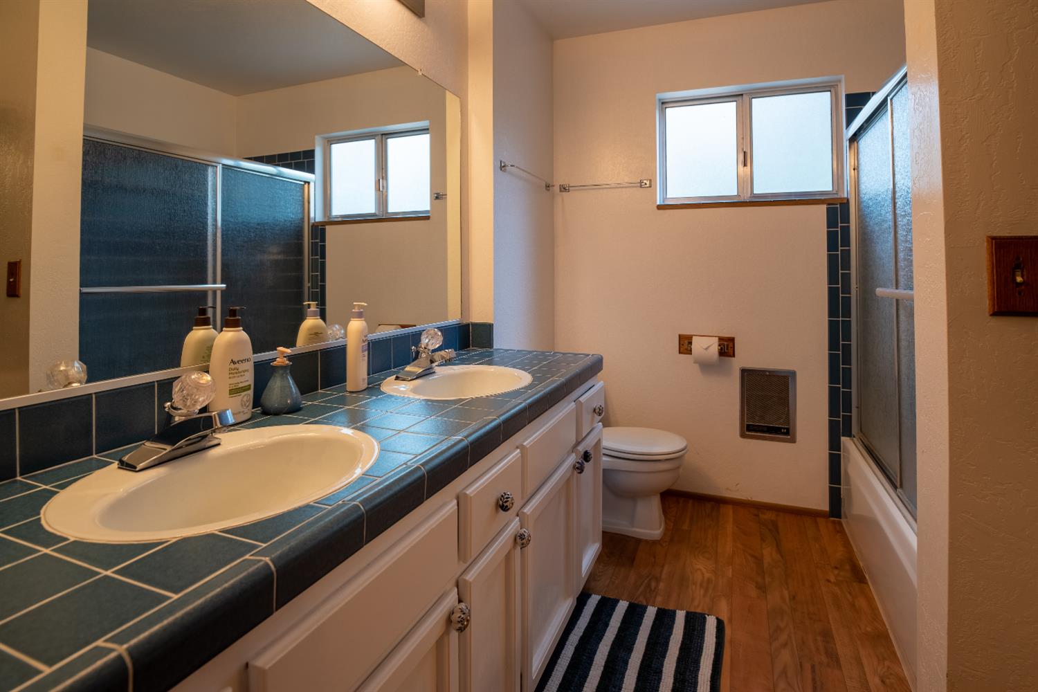 3790 Apache Road Arnold, CA 95223 - Photo 10 of 41 a bathroom with a granite countertop sink a toilet a mirror and shower