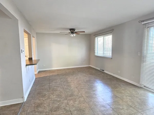 a view of a livingroom with a ceiling fan and window