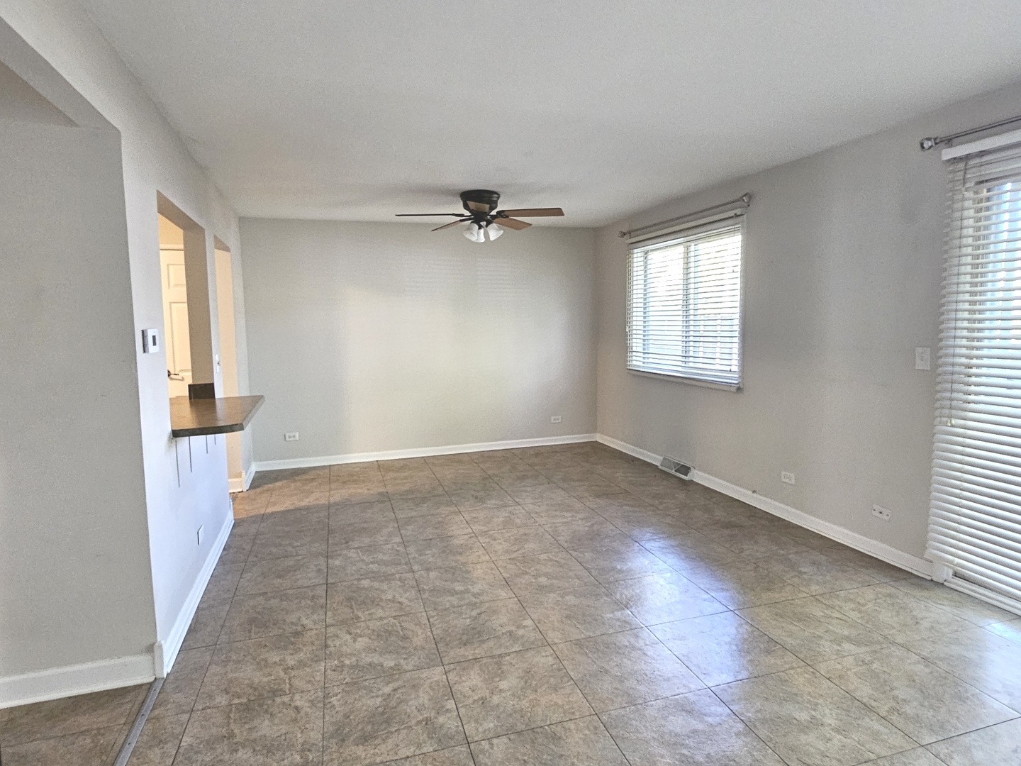 228 Monroe Road Bolingbrook, IL 60440 - Photo 3 of 14 a view of a livingroom with a ceiling fan and window