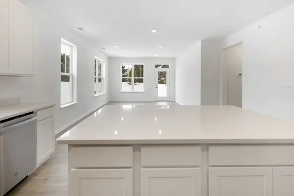 a view of an empty room with closet and wooden floor