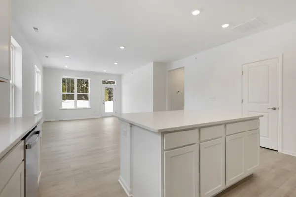a view of an empty room with window and cabinet