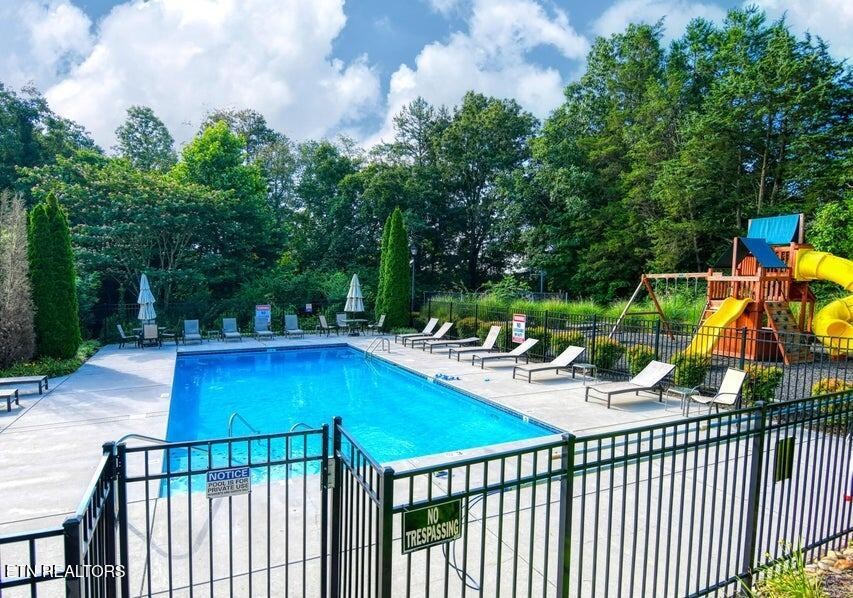 8508 Bowsong Lane Powell, TN 37849 - Photo 25 of 28 a view of a swimming pool with a patio and fire pit