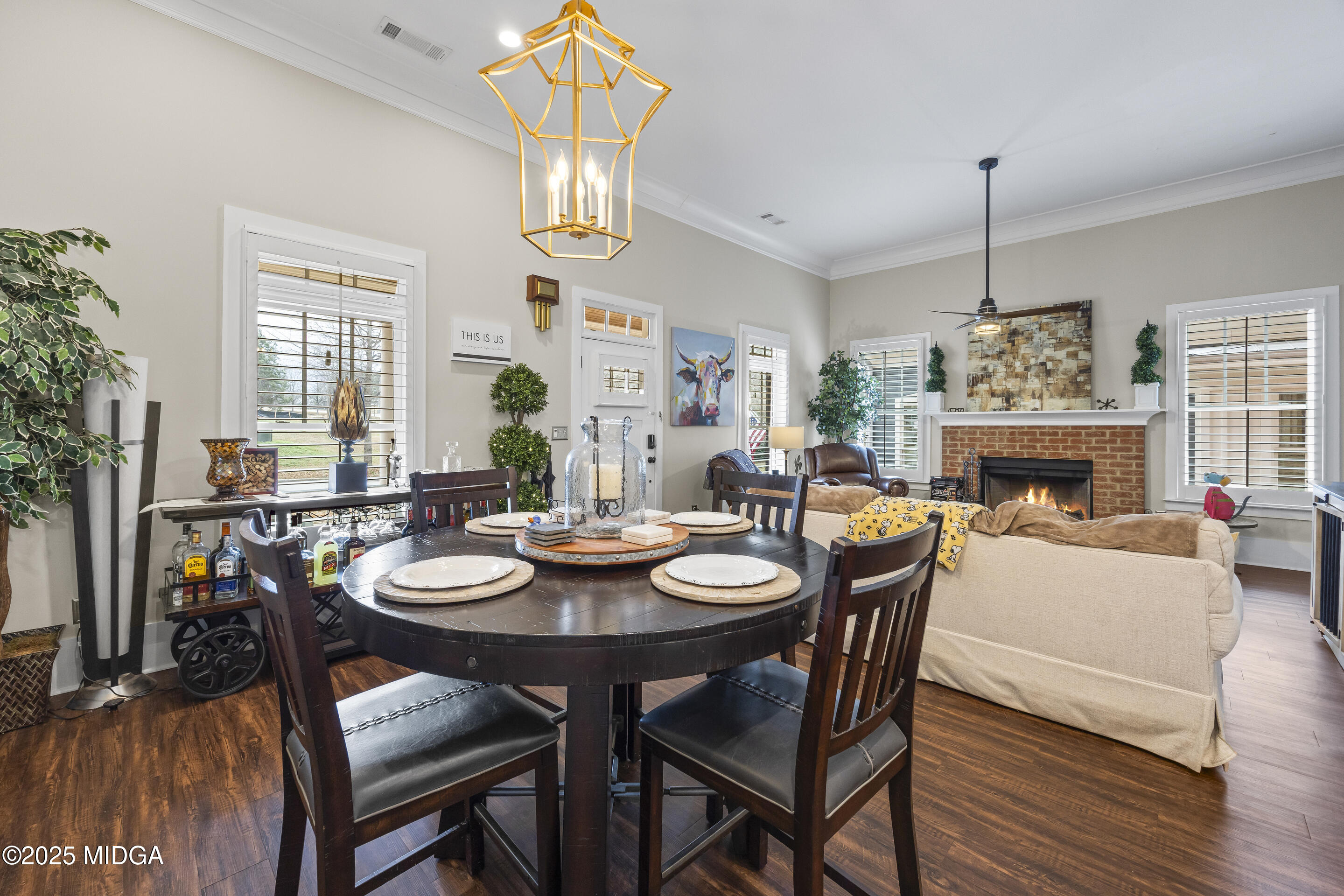 4121 North Swann Street Covington, GA 30014 - Photo 12 of 52 a dining room with furniture a chandelier and wooden floor