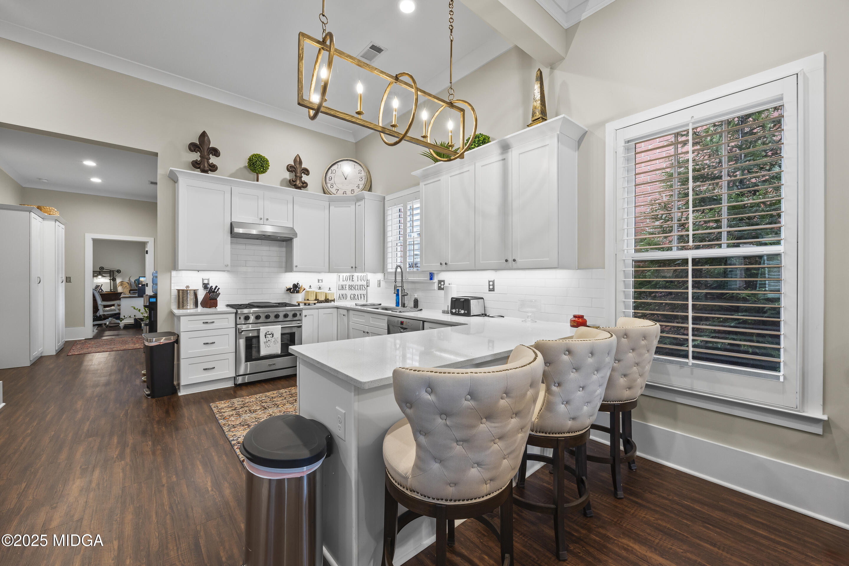 4121 North Swann Street Covington, GA 30014 - Photo 13 of 52 a large white kitchen with a table and chairs