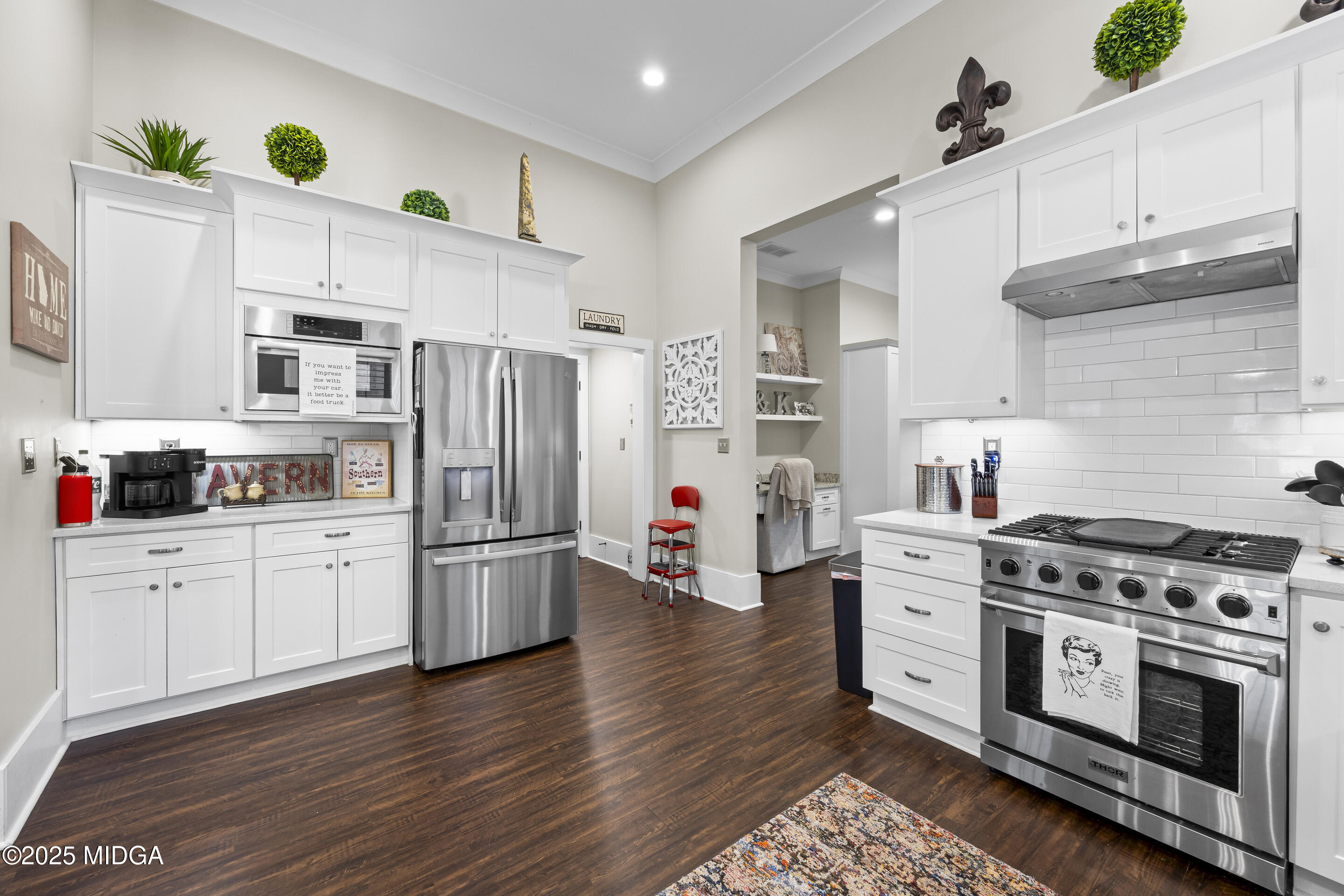 4121 North Swann Street Covington, GA 30014 - Photo 16 of 52 a kitchen with stainless steel appliances a stove a sink cabinets and a refrigerator