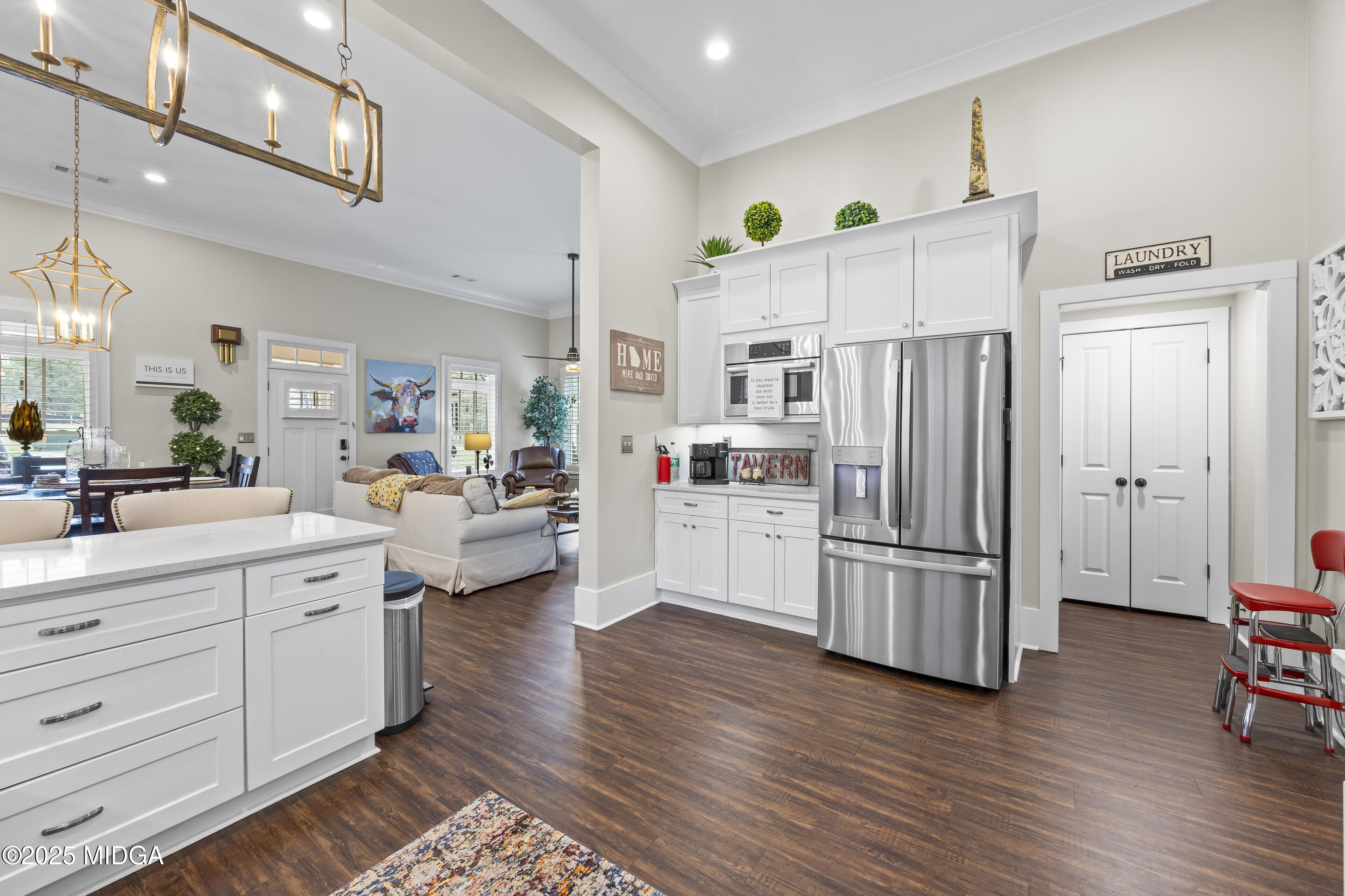 4121 North Swann Street Covington, GA 30014 - Photo 17 of 52 a kitchen with stainless steel appliances a refrigerator sink and cabinets