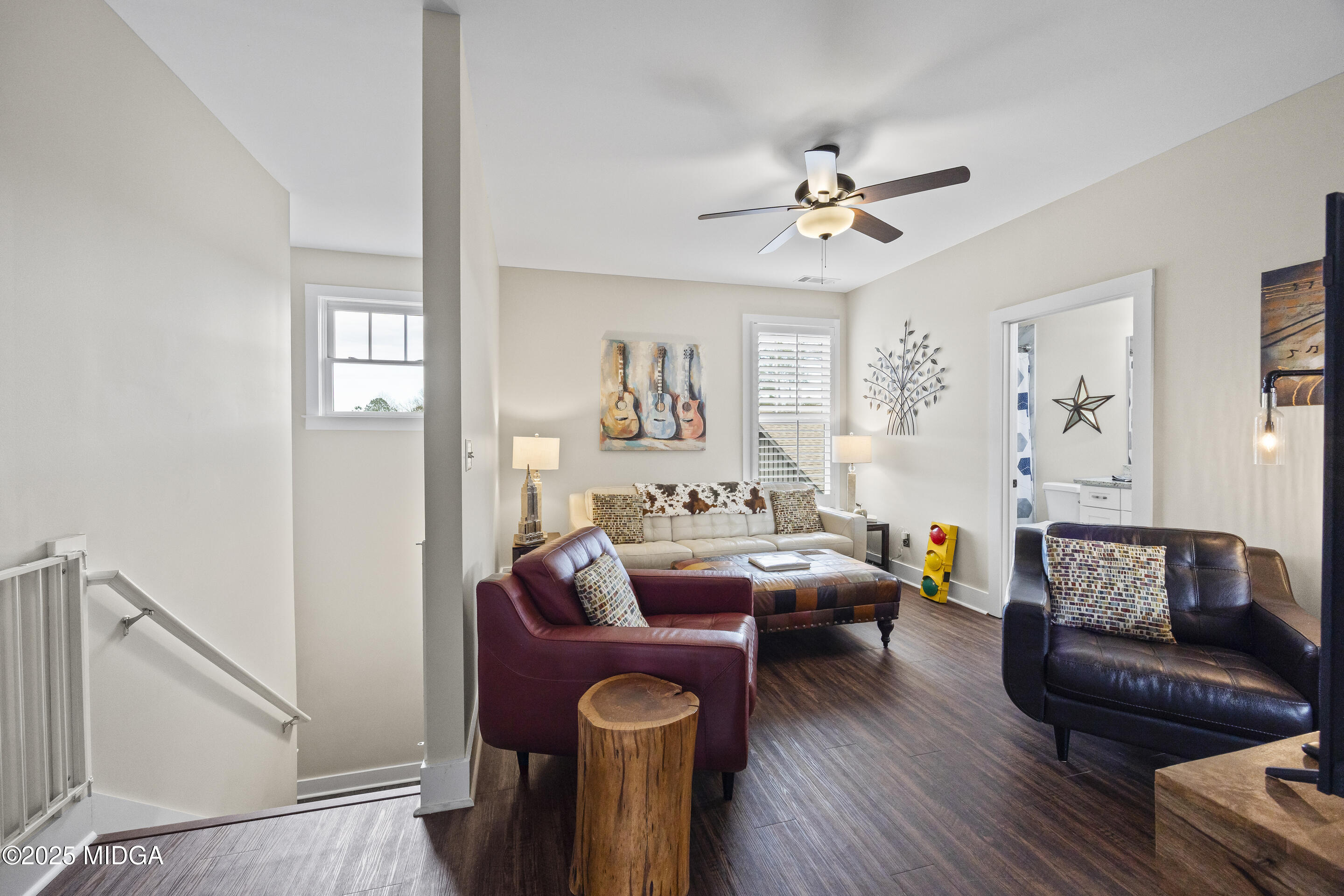4121 North Swann Street Covington, GA 30014 - Photo 26 of 52 a living room with furniture a ceiling fan and a wooden floor