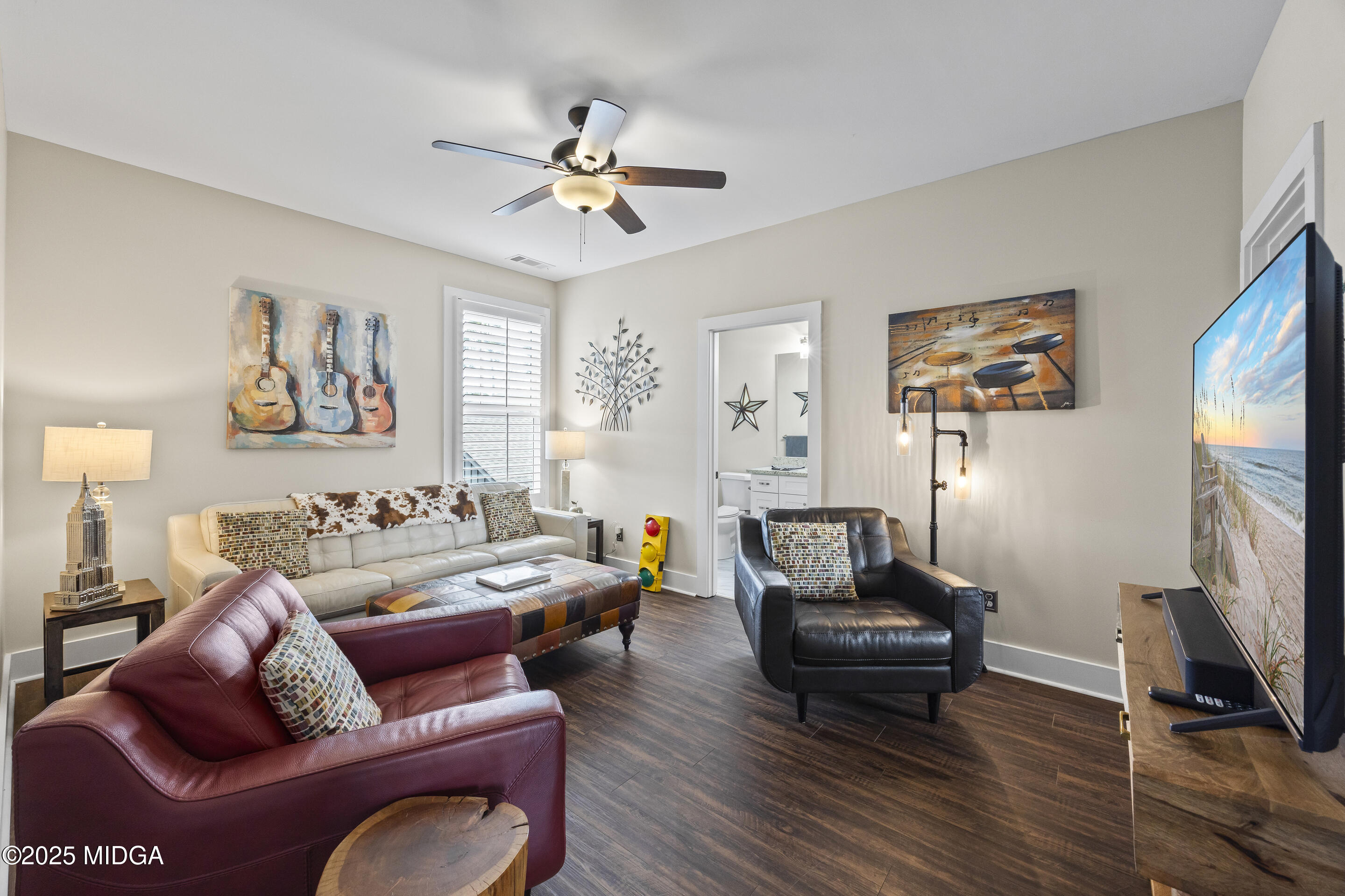 4121 North Swann Street Covington, GA 30014 - Photo 27 of 52 a living room with furniture a ceiling fan and a window