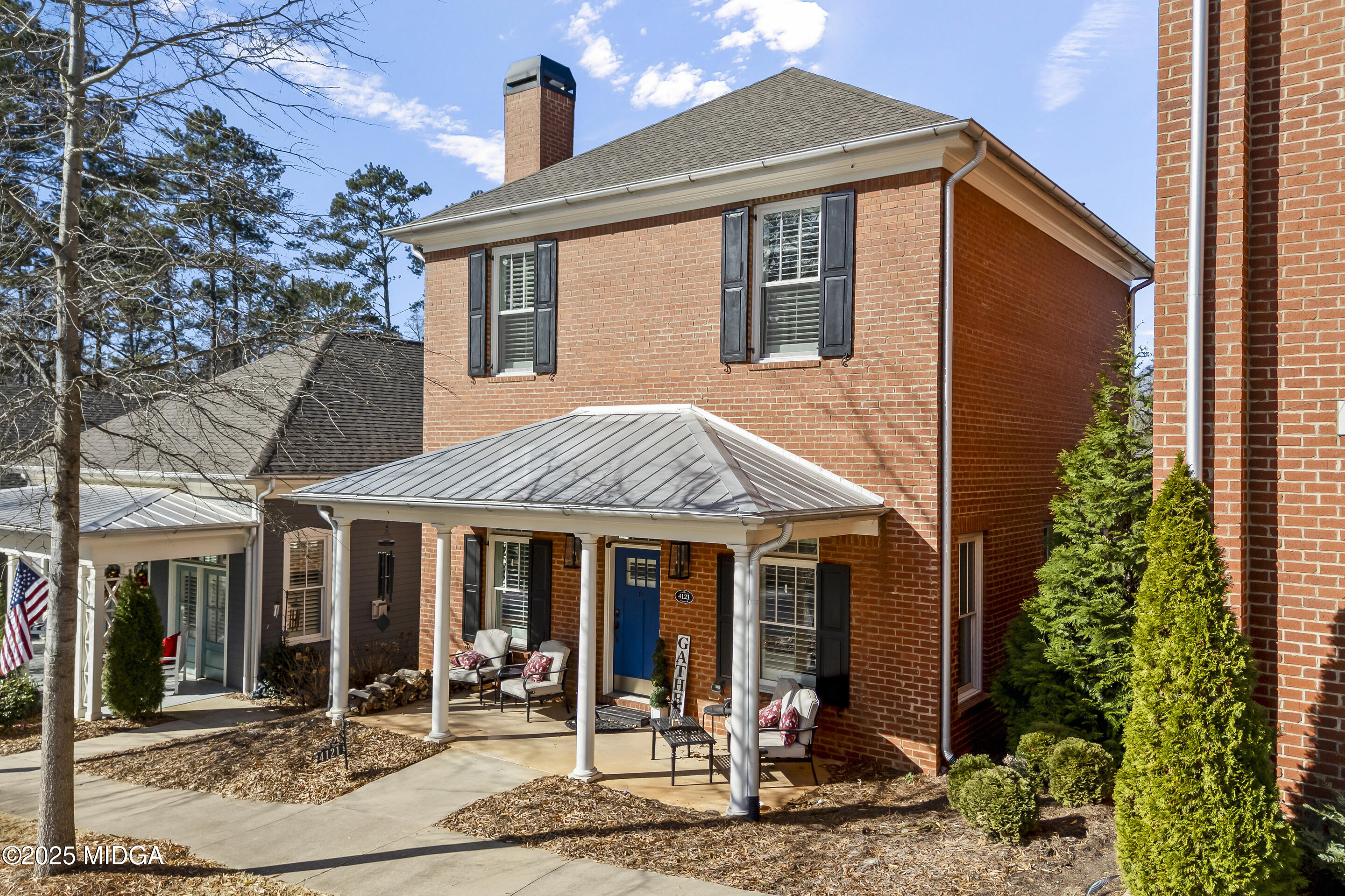 4121 North Swann Street Covington, GA 30014 - Photo 4 of 52 a view of a brick house with potted plants and a table