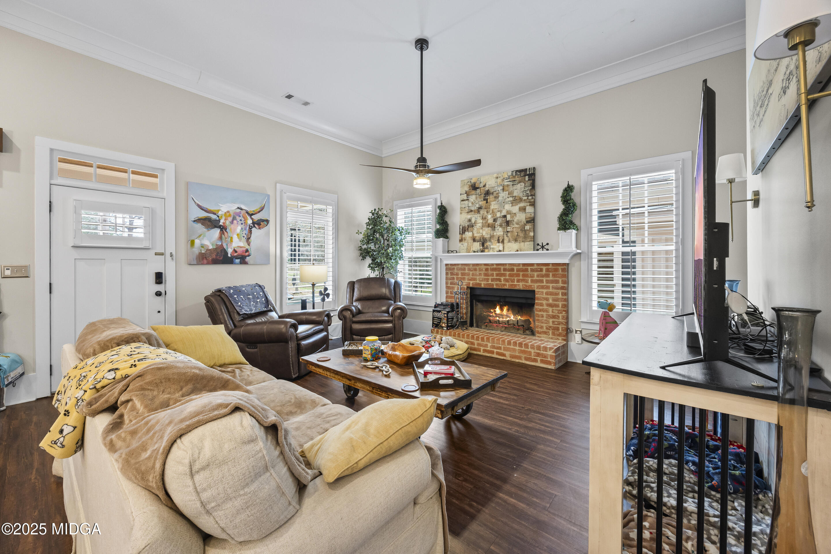 4121 North Swann Street Covington, GA 30014 - Photo 7 of 52 a living room with furniture a flat screen tv and a fireplace