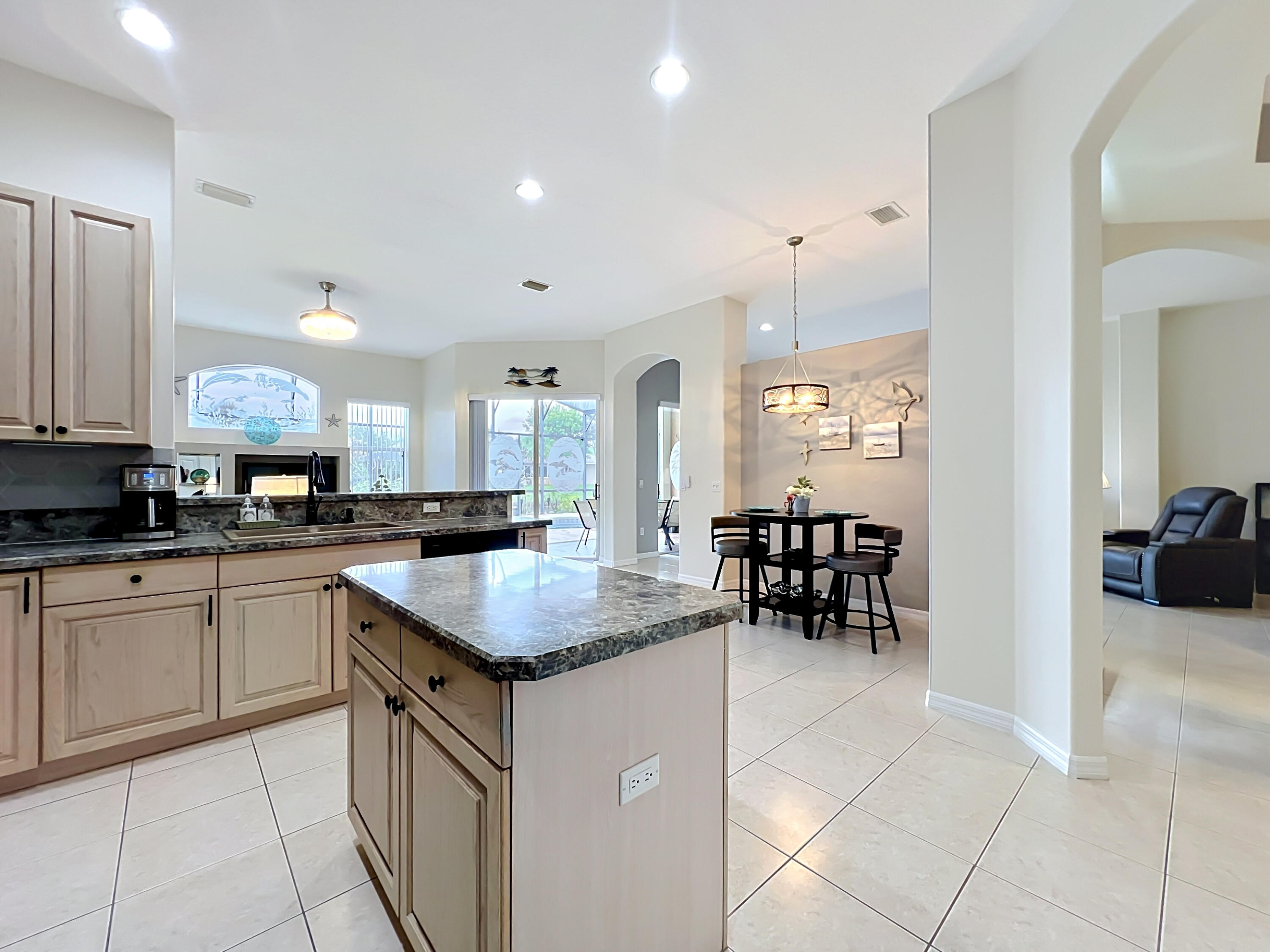 1343 Shoreline Circle Sebastian, FL 32958 - Photo 11 of 36 a kitchen with sink cabinets and dining table chair