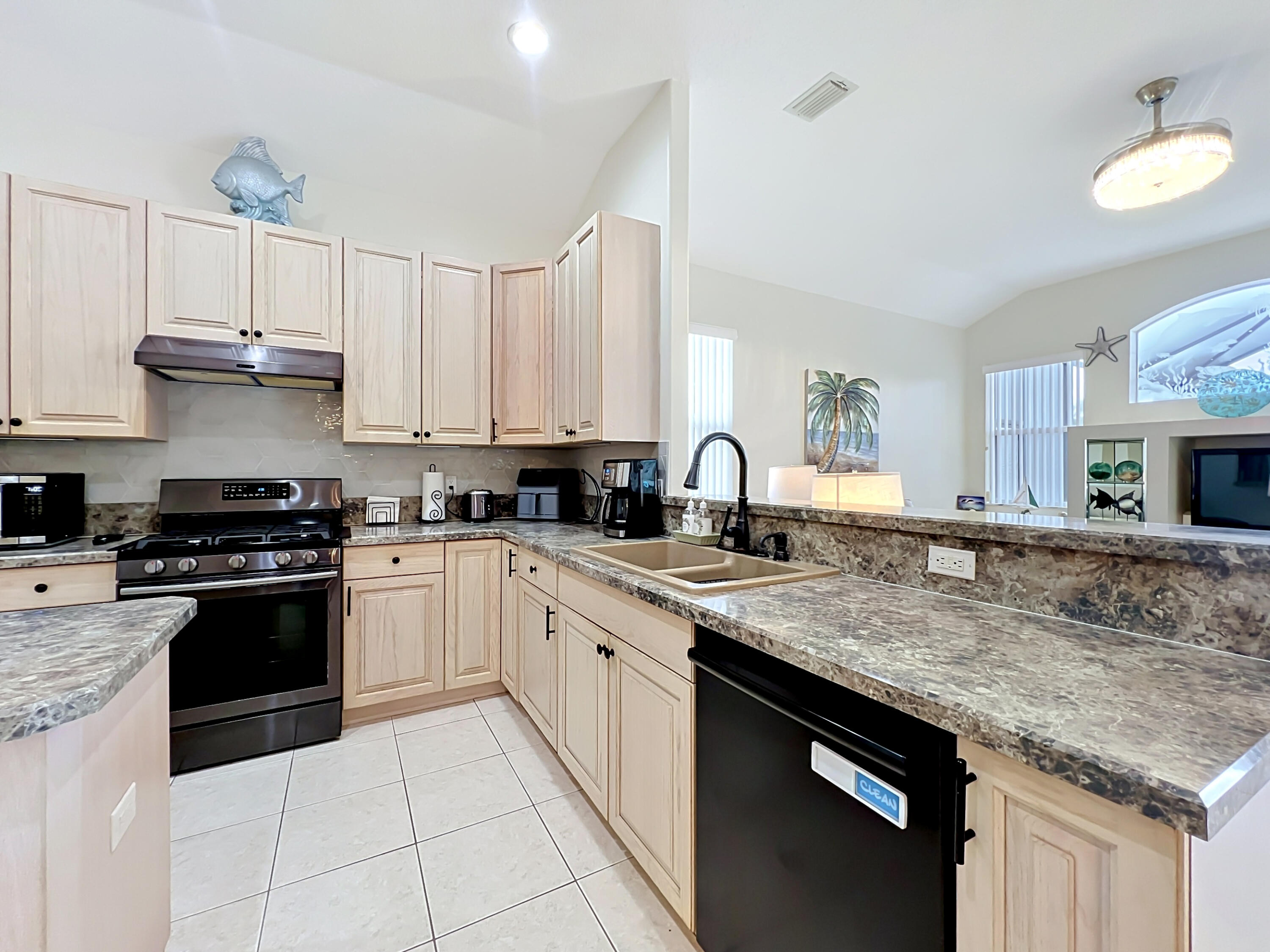 1343 Shoreline Circle Sebastian, FL 32958 - Photo 17 of 36 a kitchen with stainless steel appliances granite countertop a stove sink and cabinets