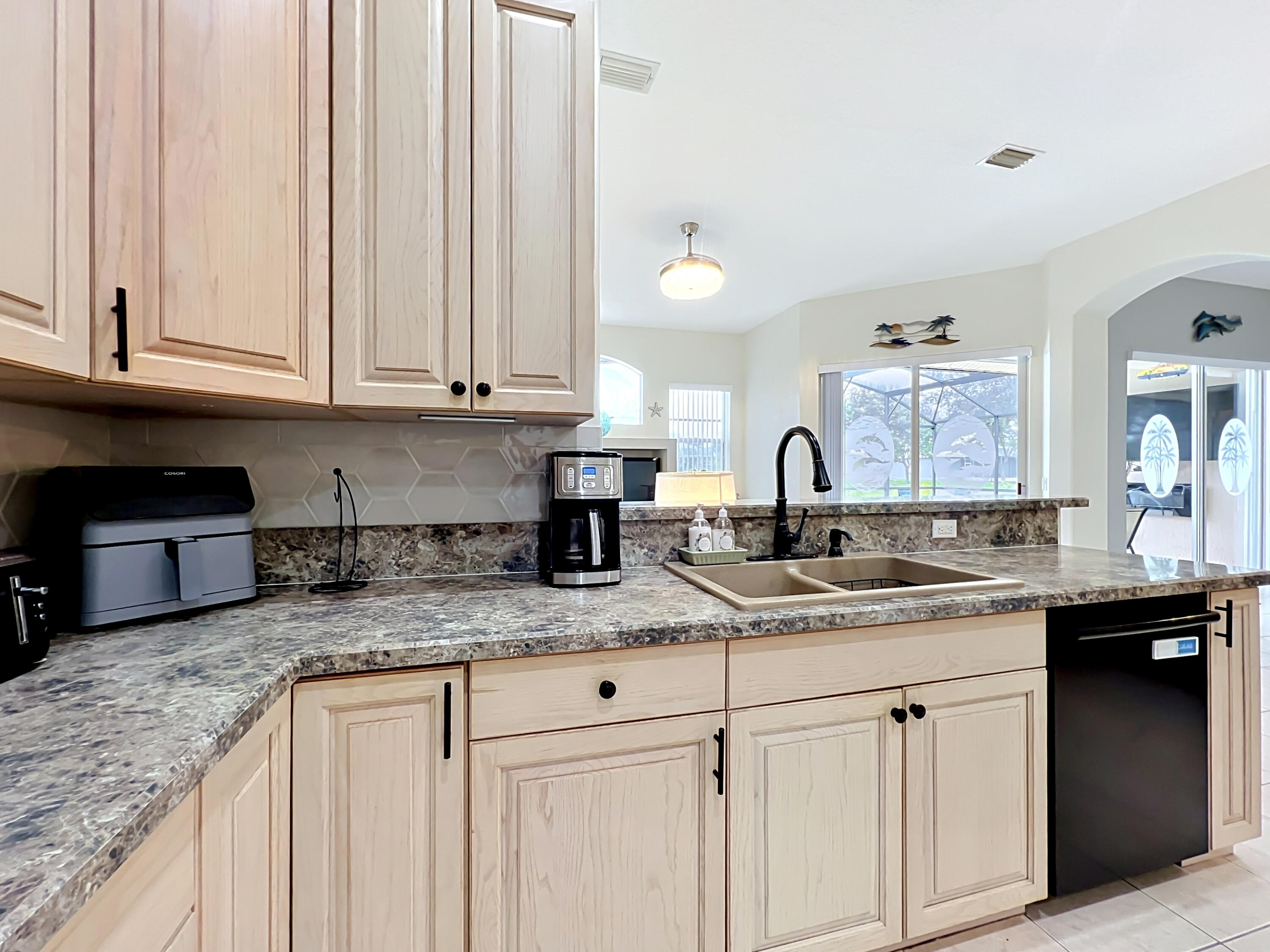 1343 Shoreline Circle Sebastian, FL 32958 - Photo 18 of 36 a kitchen with granite countertop a sink and cabinets
