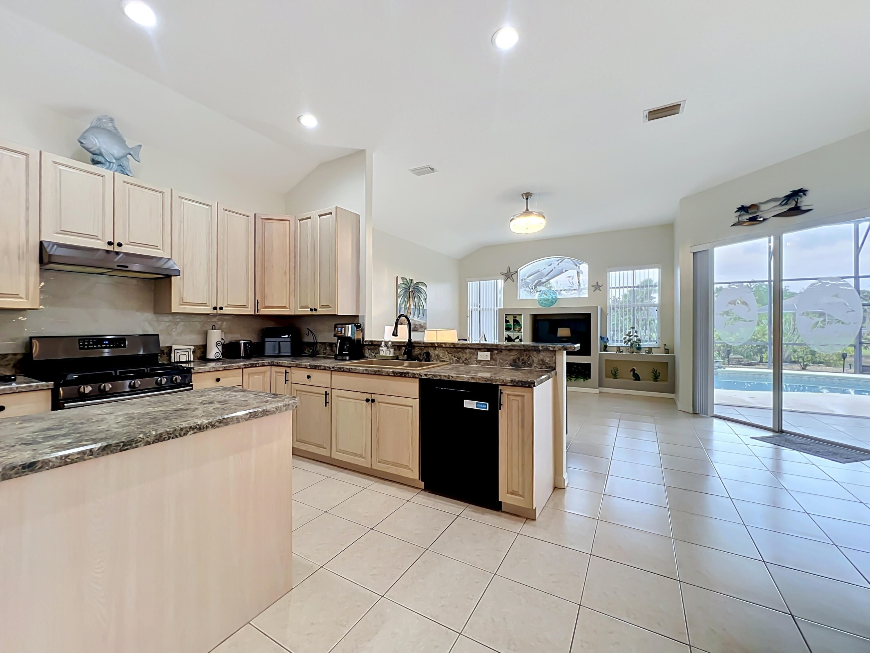 1343 Shoreline Circle Sebastian, FL 32958 - Photo 20 of 36 a large kitchen with kitchen island granite countertop a large counter top stainless steel appliances and cabinets