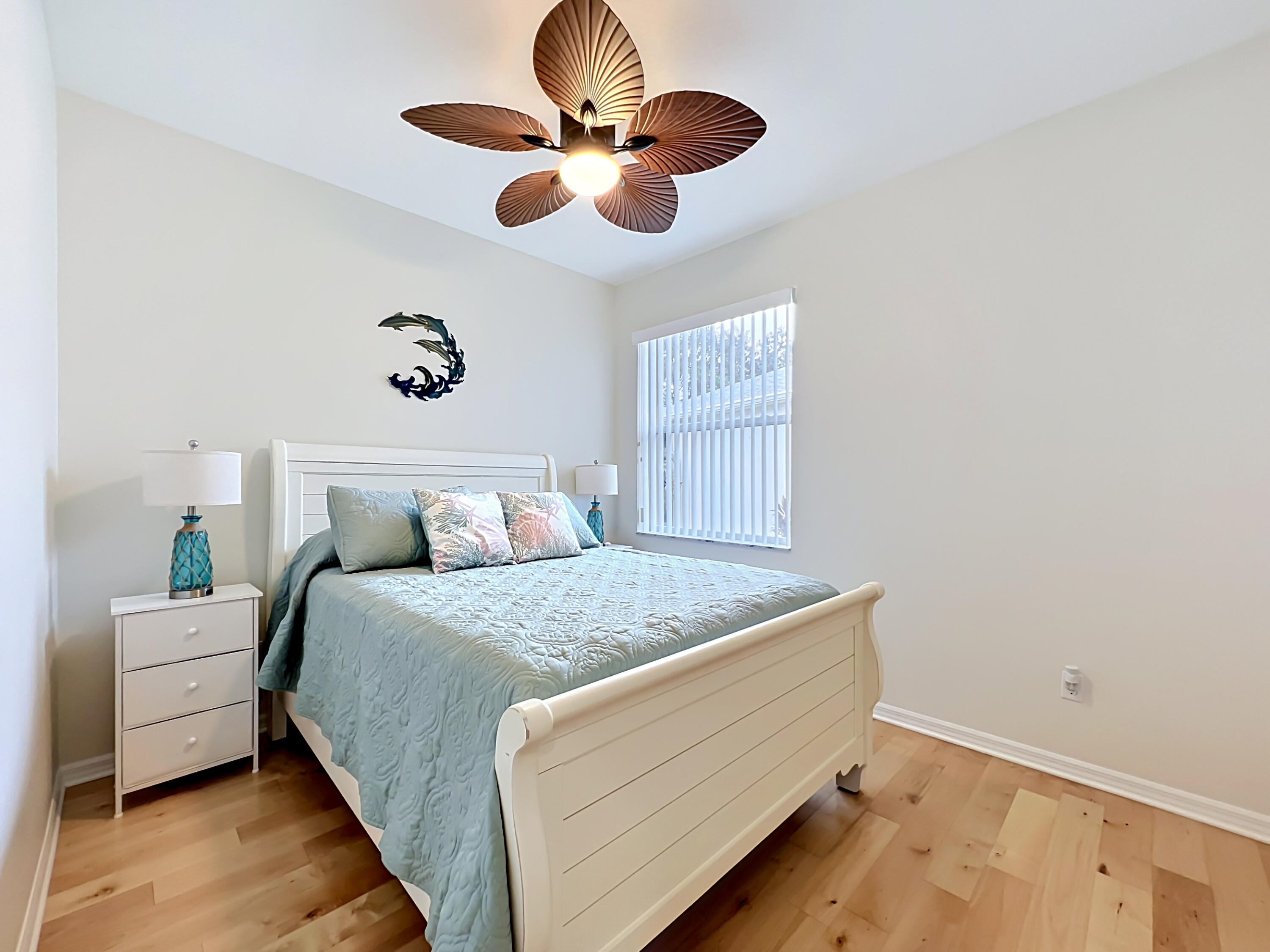 1343 Shoreline Circle Sebastian, FL 32958 - Photo 21 of 36 a bedroom with a bed and a chandelier