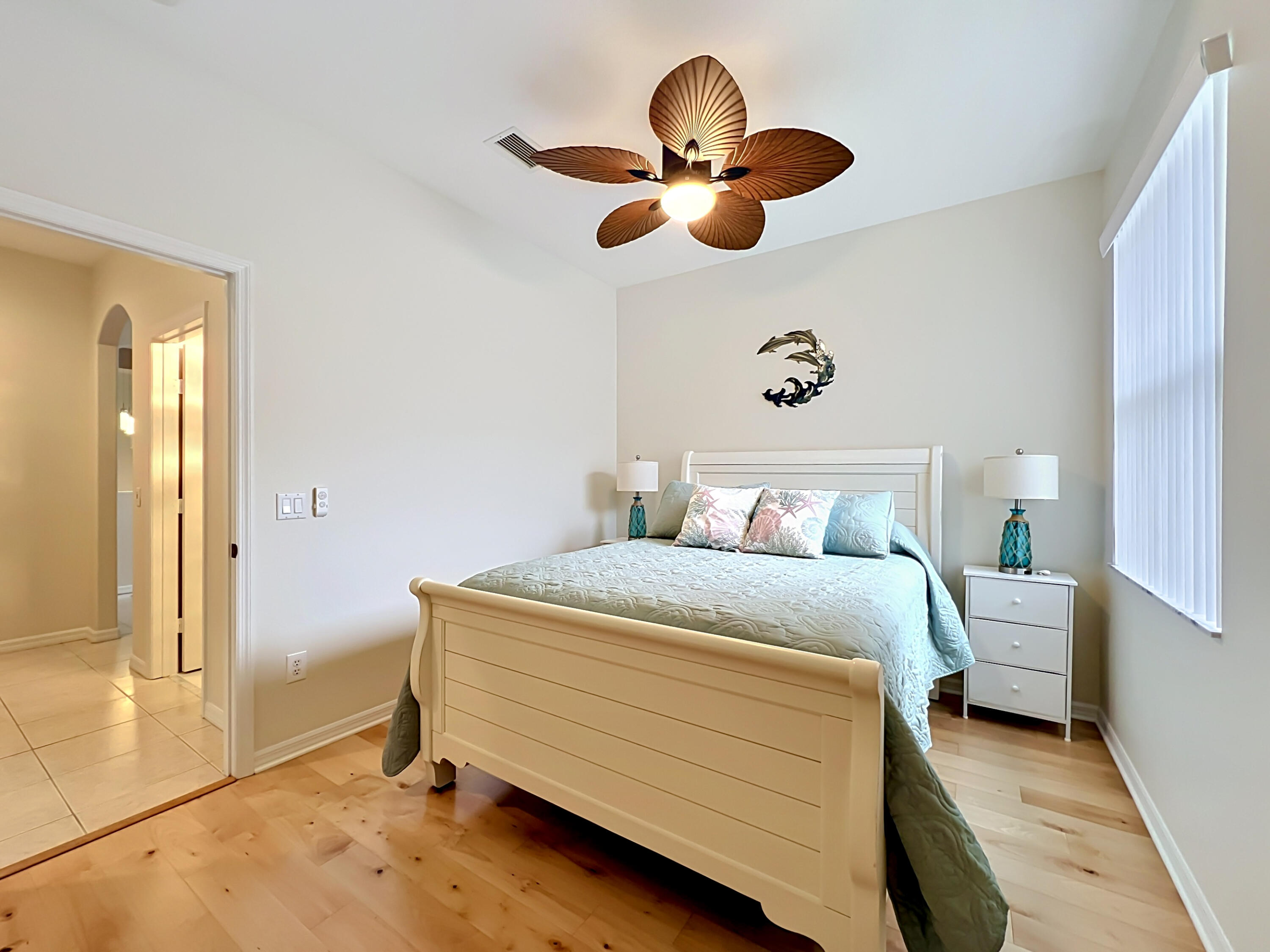 1343 Shoreline Circle Sebastian, FL 32958 - Photo 22 of 36 a bedroom with a bed and a chandelier