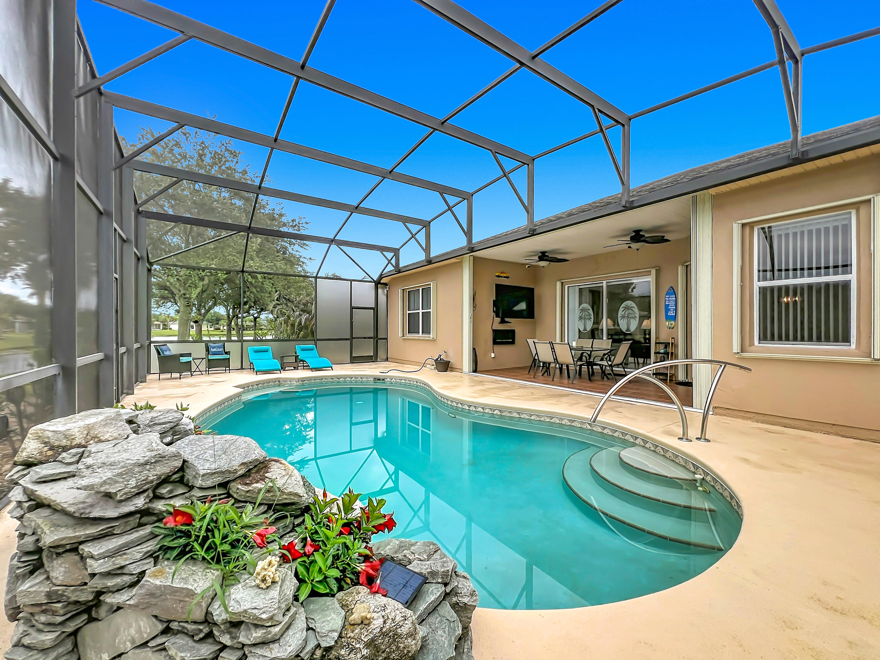 1343 Shoreline Circle Sebastian, FL 32958 - Photo 33 of 36 a view of a swimming pool with an outdoor seating